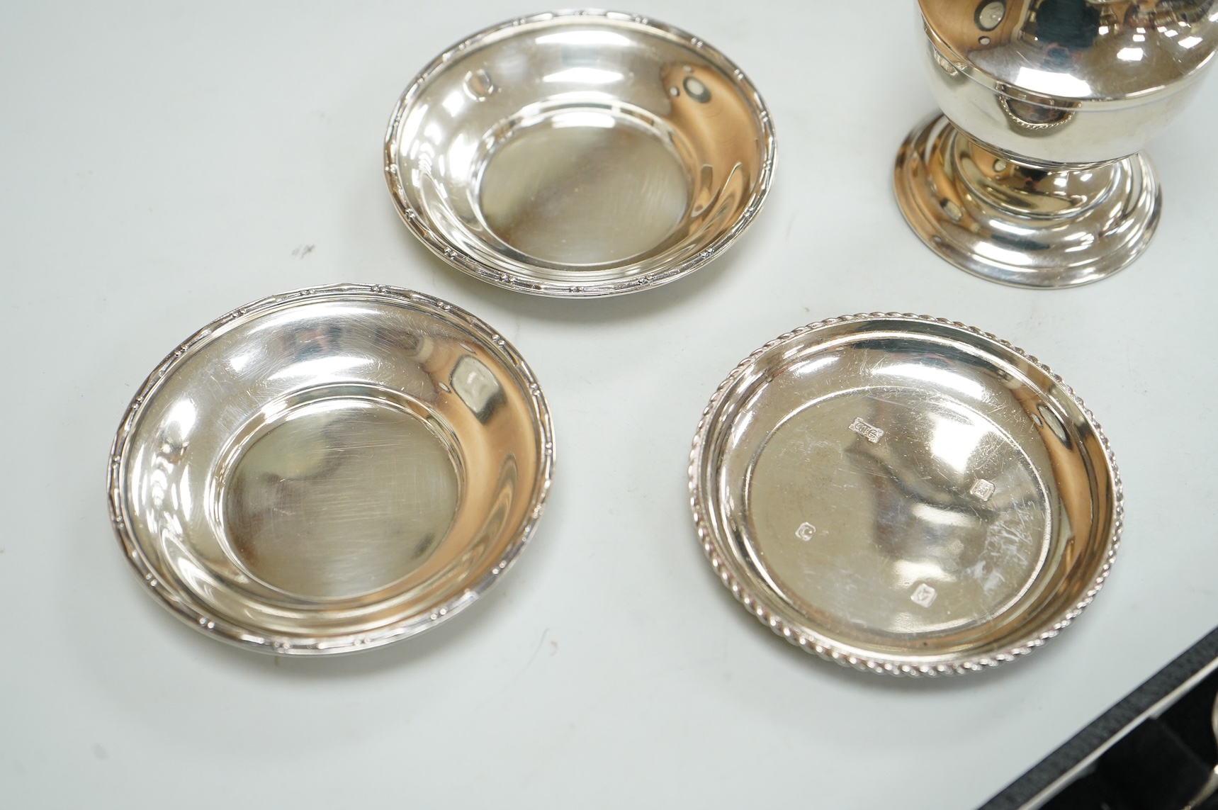 A George V silver sugar caster by Walker & Hall London 1932, 16cm, together with three silver nut dishes and a cased set of six silver coffee spoons.